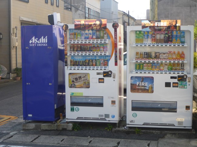 Streetside vending machines, including cans of hot coffee.