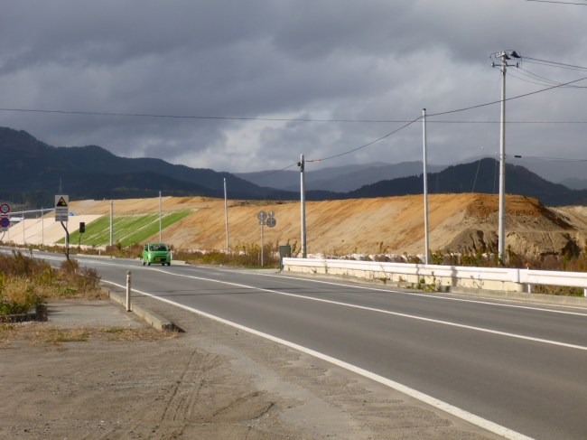 Huge mounds of earth, being grassed over, which will have trees planted on them.